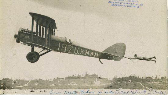 Photo of person hanging on to airplane