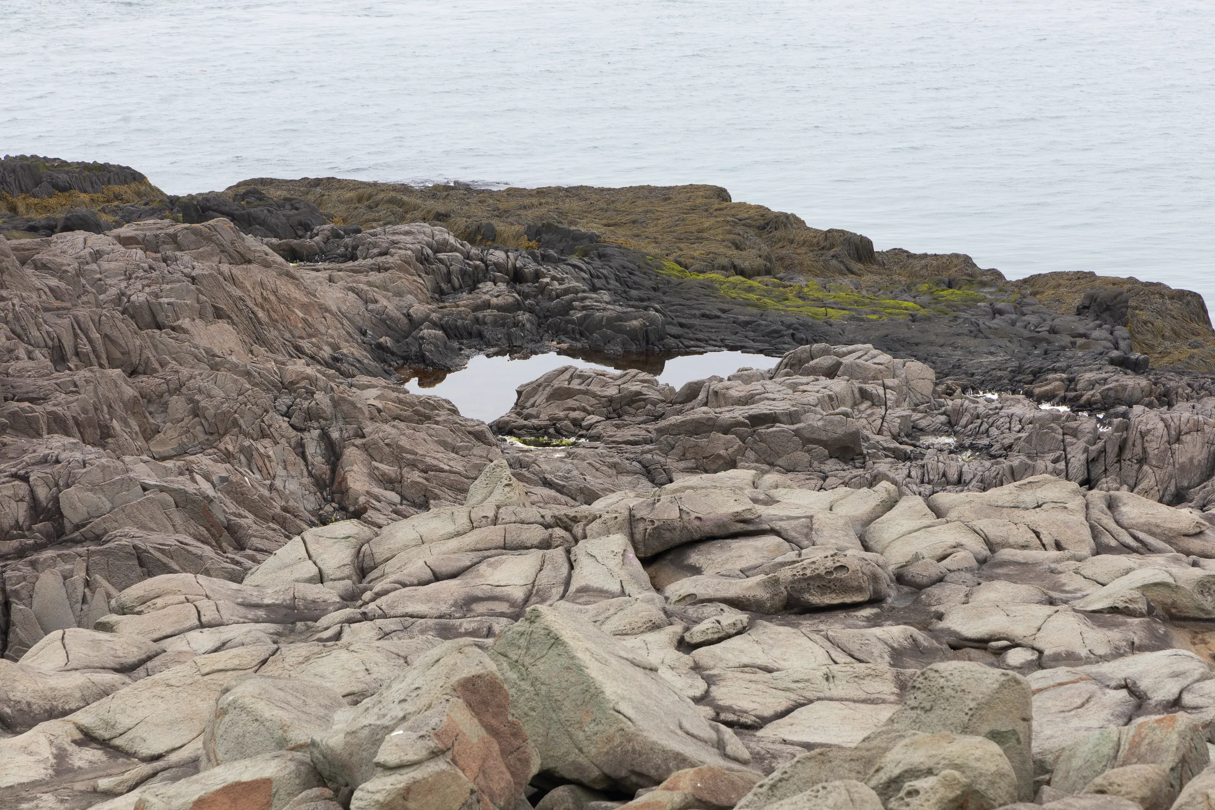 rocks tumbling down to the ocean