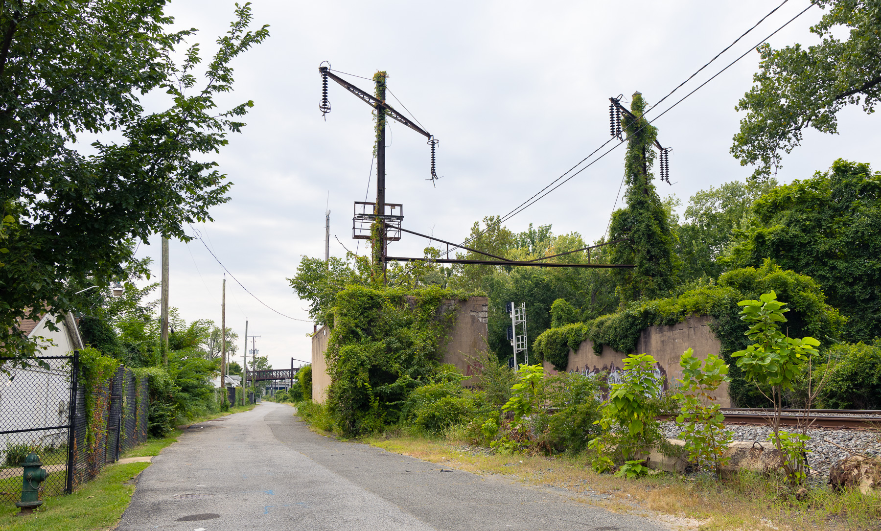photo of a rail line with old electrification